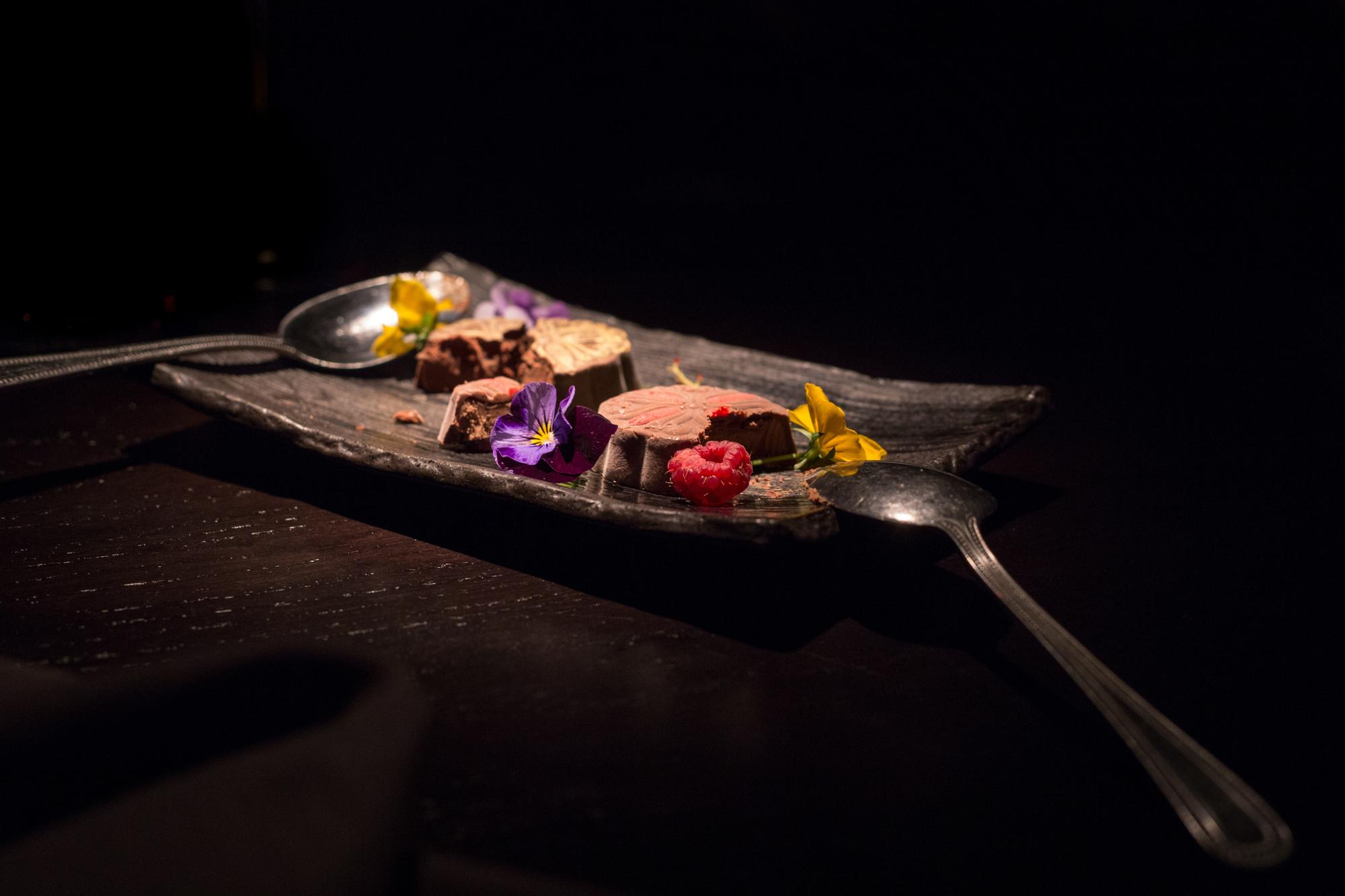Set of plated tasting courses on black surface
